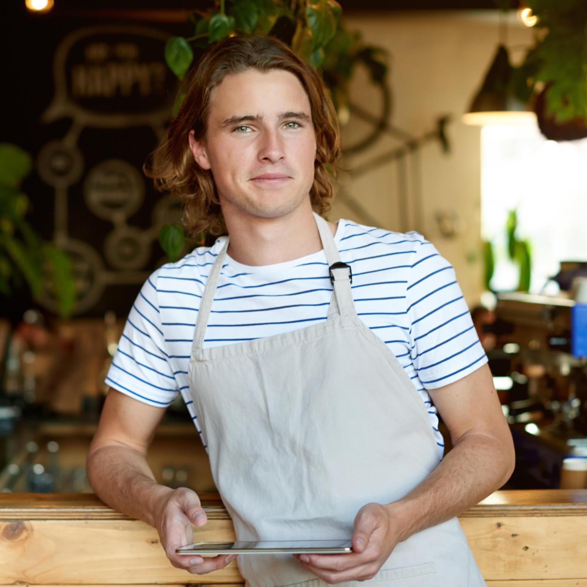 Young man working in a coffee shop